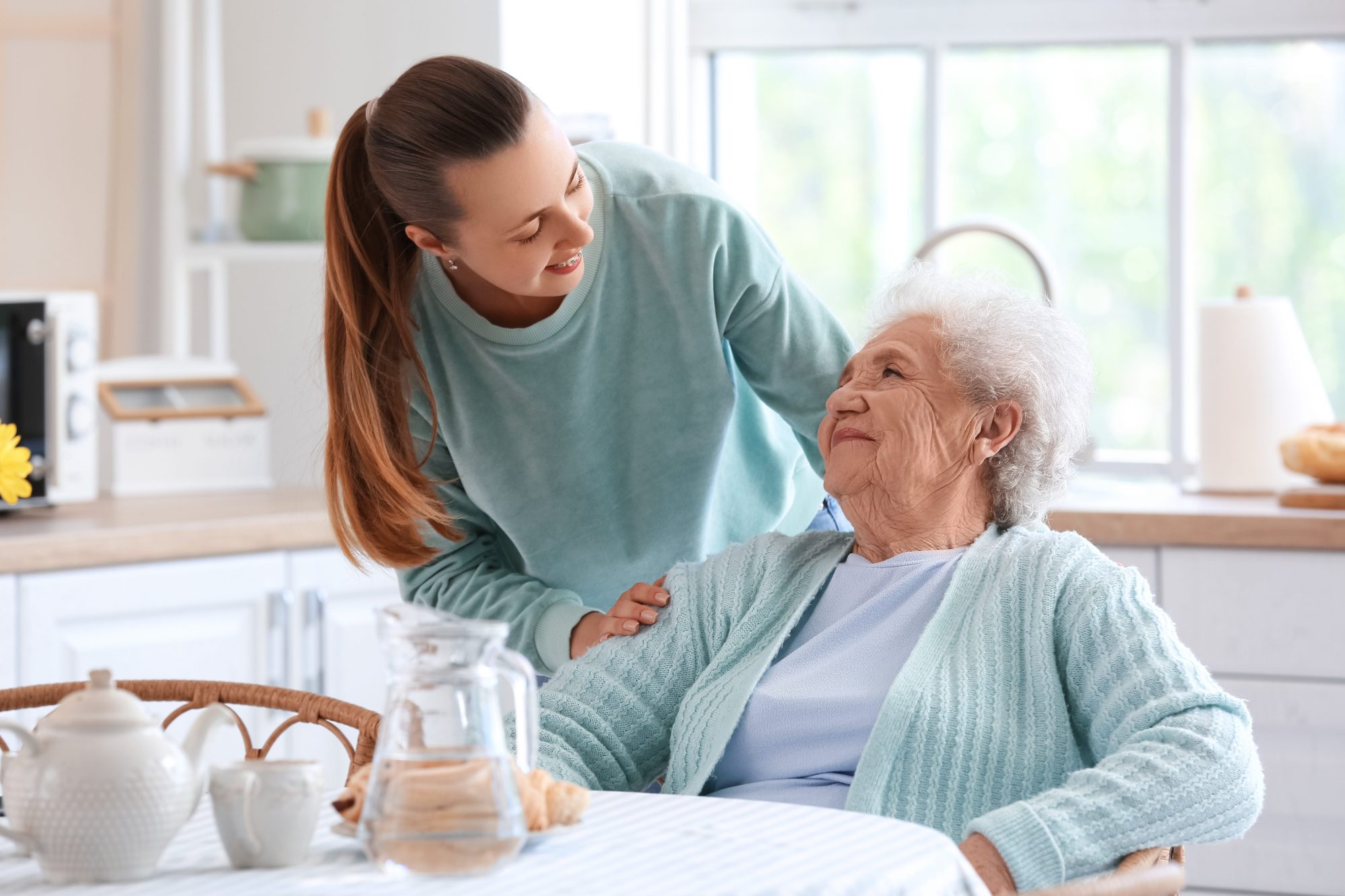 Woman caring for her elderly mother in her home, to show cohabiting with senior parent suggested by LaGrange Elder Lawyers.